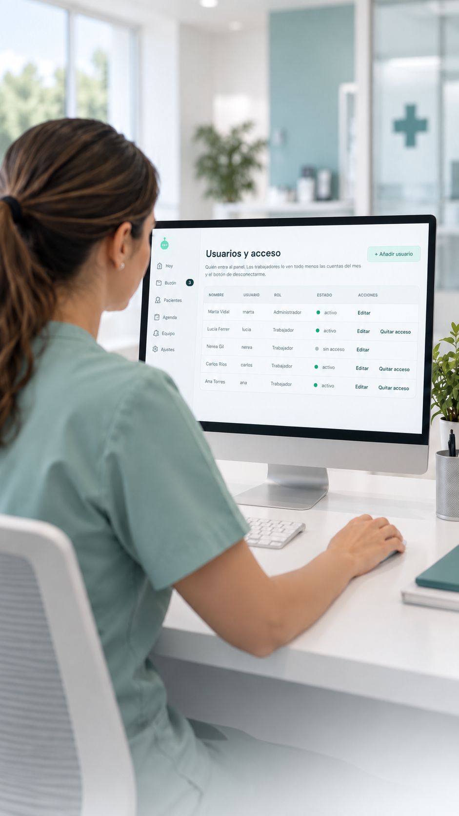 A receptionist seen from behind at the reception panel, on the users and access screen showing each team member's role and status